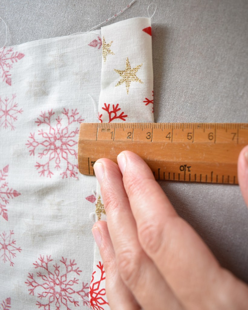 Measure and iron 3cm hem all the way round